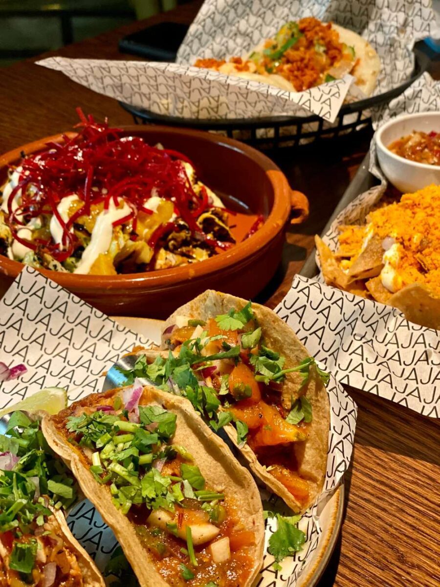 several small dishes of food on white paper that says JAJA, in Bergen, norway