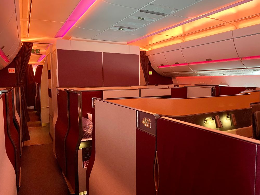 an airplane business class cabin, the qatar qsuites