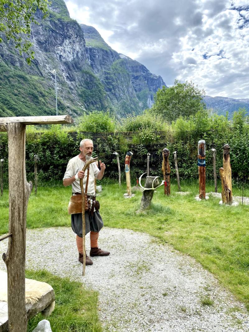 A Viking reenactor in Norway showing painted poles symbolising the Norse gods.
